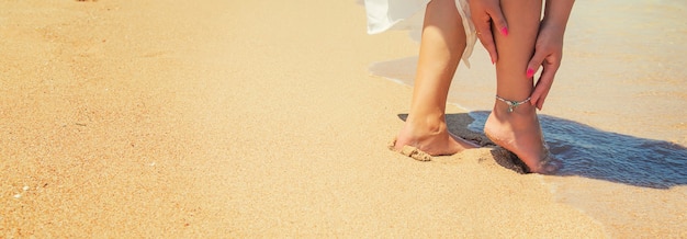 Jambes d'une fille au bord de la mer.