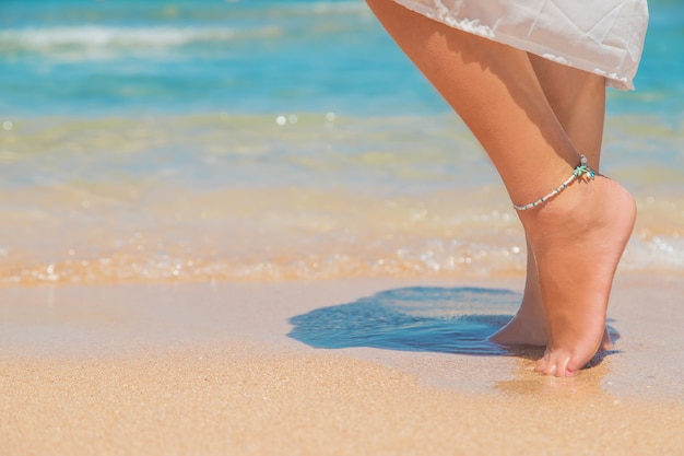 Jambes d'une fille au bord de la mer