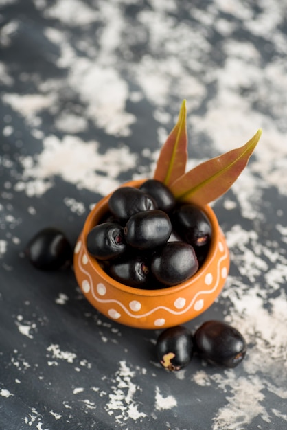 Jambolan prune ou jambul ou Jamun fruit, prune de Java avec feuille sur pierre texturée
