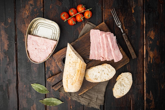 Jambon cuit du sandwich au pain peut sur la vieille vue de dessus de fond de table en bois sombre mise à plat