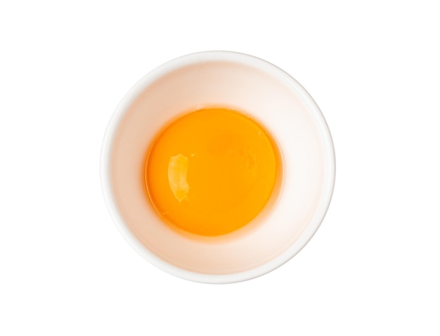 Jaunes d'œufs dans un bol Un jaune d'œuf de poule frais séparé du blanc pour la recette de cuisson 1 jaune biologique dans un bol en verre