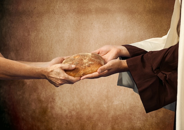 Jésus donne le pain à un mendiant.