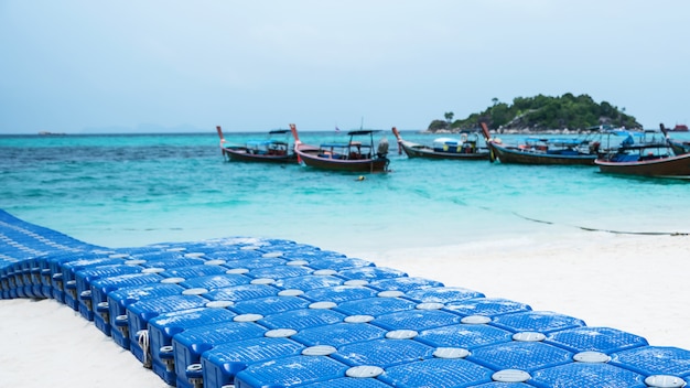 jetée faite de bouées flottantes sur une plage tropicale