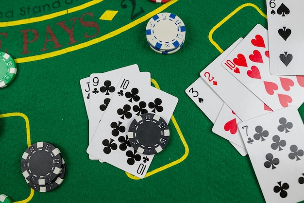 Jetons de cartes de poker multicolores disposés sur une nouvelle table de poker verte Concept de poker Concept d'excitation