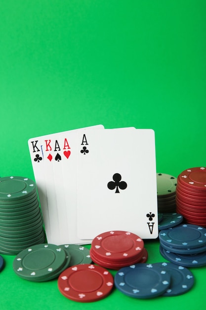 Jetons de jeu et carte de poker sur mur vert. Vue de dessus