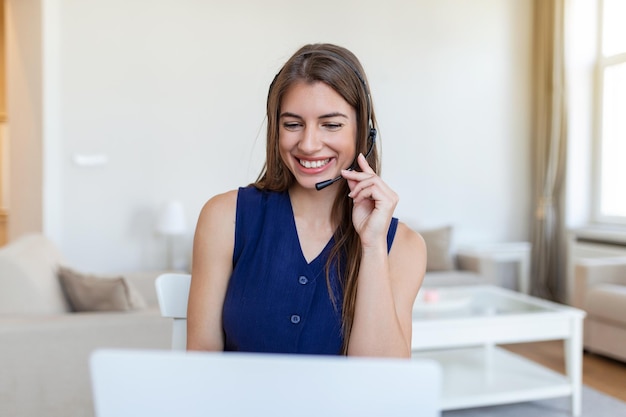 Jeune agent de centre d'appels travaillant dans un bureau Portrait d'une jeune femme d'affaires joyeuse parlant sur un casque aux clients tout en travaillant à l'intérieur du bureau