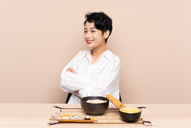 Jeune, asiatique, femme, table, bol, nouilles, sushi, regarder, côté