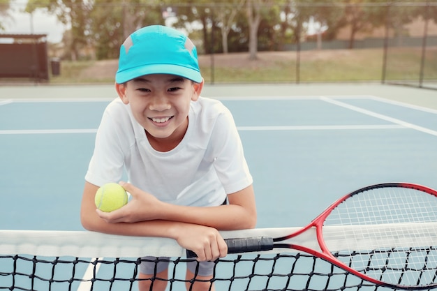 Jeune, asiatique, garçon, tennis, joueur, sur, court extérieur bleu