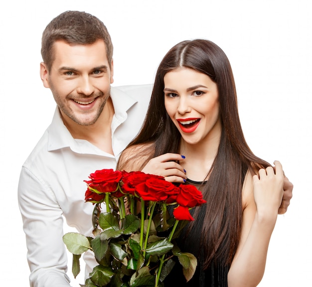 Jeune beau couple avec fleurs sur blanc