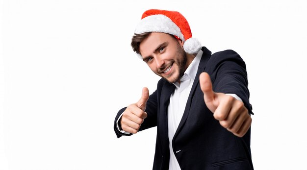 Jeune beau mec en costume d'affaires et bonnet de Noel