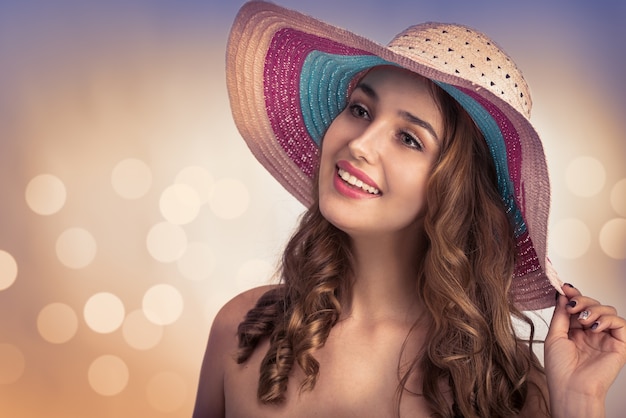 Jeune belle femme avec un chapeau pendant l'été chaud