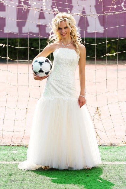 Jeune belle mariée debout sur la porte avec ballon