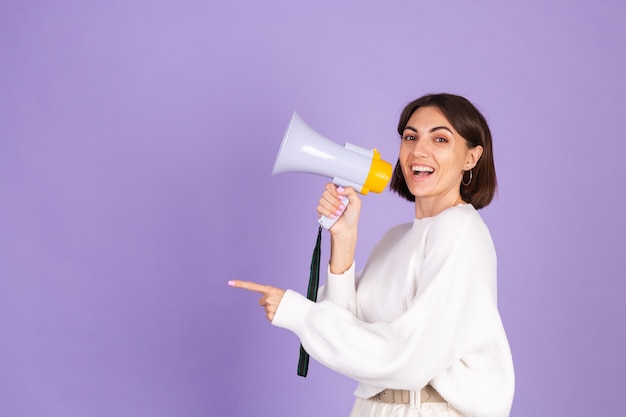 Jeune Brune En Pull Décontracté Blanc Isolé Sur Mur Violet