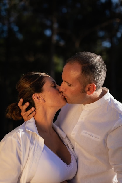 Jeune couple amoureux s'embrasse passionnément pendant la grossesse