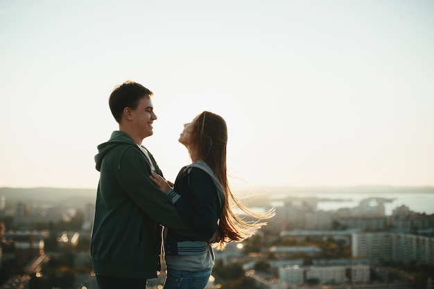 Jeune couple élégant embrassant sur le toit