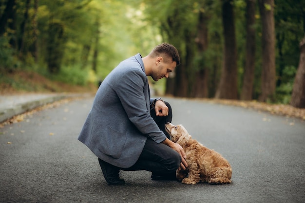 Photo un jeune couple heureux avec un chien dans la forêt.