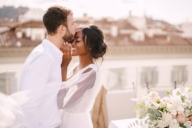 Un jeune couple s'embrasse sur une fleur.