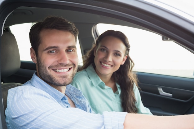 Jeune couple souriant à la caméra