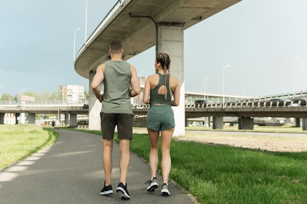 Jeune couple sportif pendant l'entraînement de jogging dans la rue de la ville