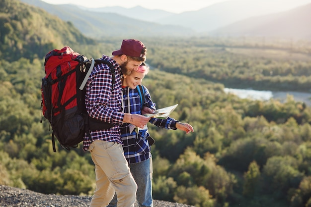 Jeune couple voyageant ensemble dans les montagnes.