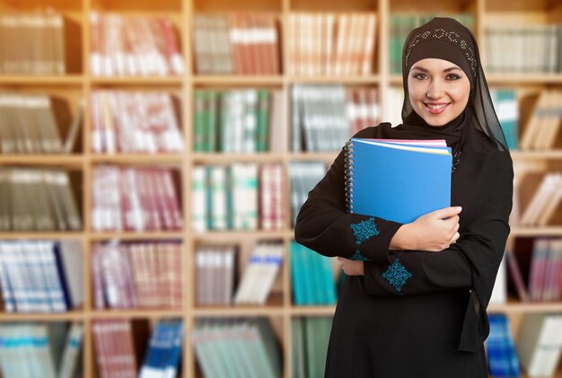 Photo une jeune étudiante arabe dans la bibliothèque