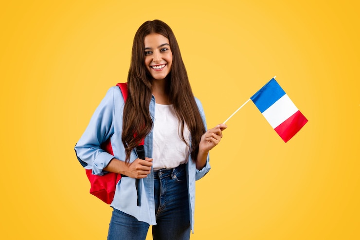 Photo une jeune étudiante caucasienne joyeuse avec le drapeau de la france combine le patriotisme et le monde universitaire