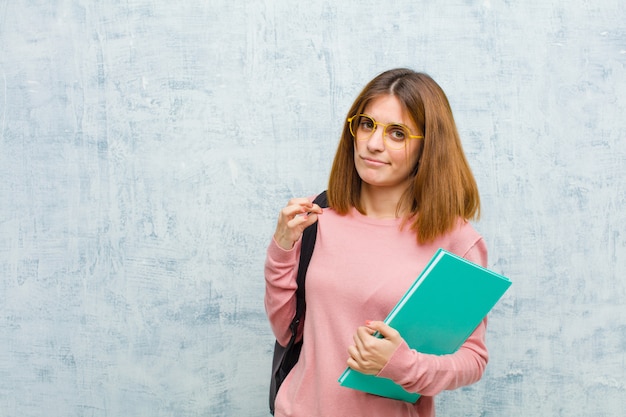 Jeune étudiante à la recherche d'arrogant, de succès, de positif et de fier, pointant vers soi