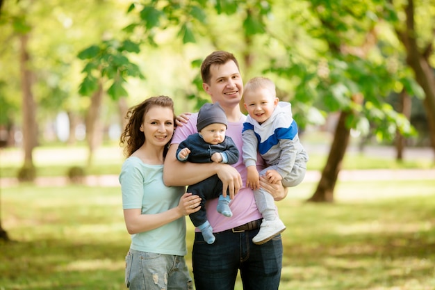 jeune famille avec deux enfants en promenade