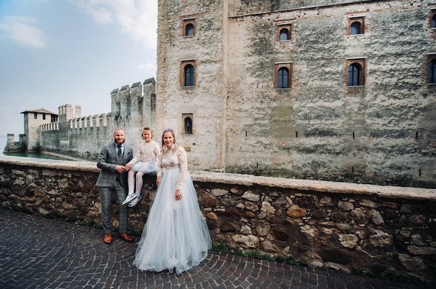 Une jeune famille heureuse se promène dans la vieille ville de Sirmione en Italie