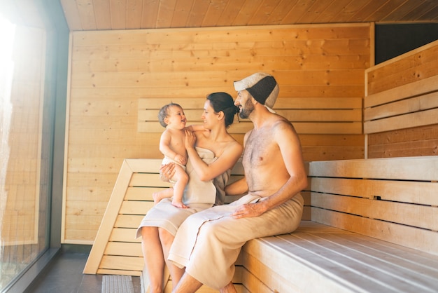 Jeune famille avec un petit garçon dans un sauna