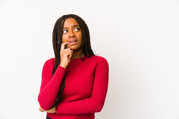 Jeune femme afro-américaine détendue penser à quelque chose en regardant un espace vide.