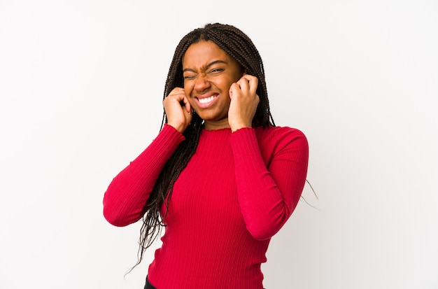 Jeune femme afro-américaine isolée couvrant les oreilles avec les mains.