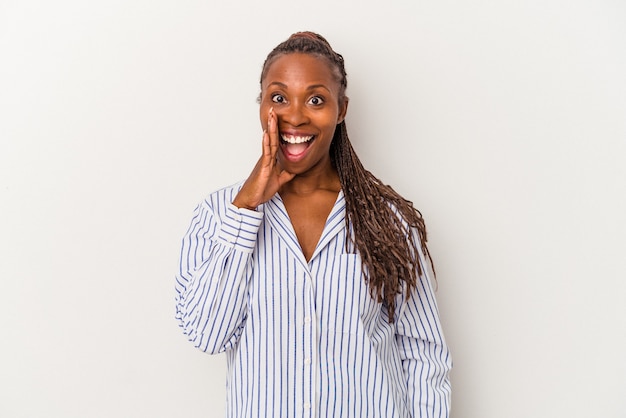 Jeune femme afro-américaine isolée sur fond blanc crie fort, garde les yeux ouverts et les mains tendues.