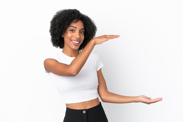 Jeune femme afro-américaine isolée sur fond blanc tenant un espace pour insérer une annonce