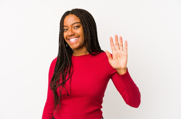 Jeune femme afro-américaine souriante joyeuse montrant le numéro cinq avec les doigts.