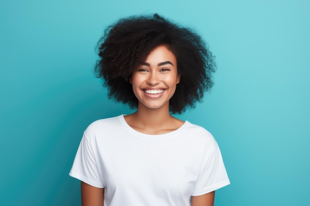 Une jeune femme afro-américaine souriante et portant un t-shirt blanc sur un fond turquoise