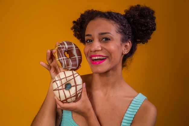 Jeune femme afro avec des beignets