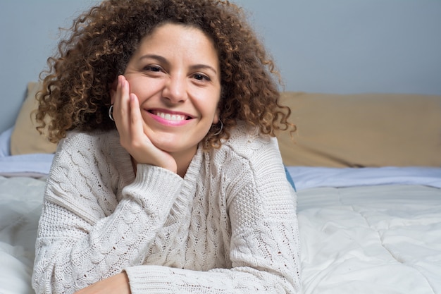 Jeune femme allongée sur le lit