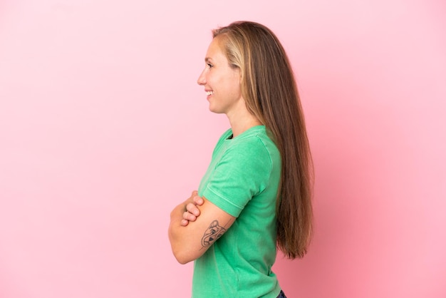 Jeune femme anglaise isolée sur fond rose en position latérale