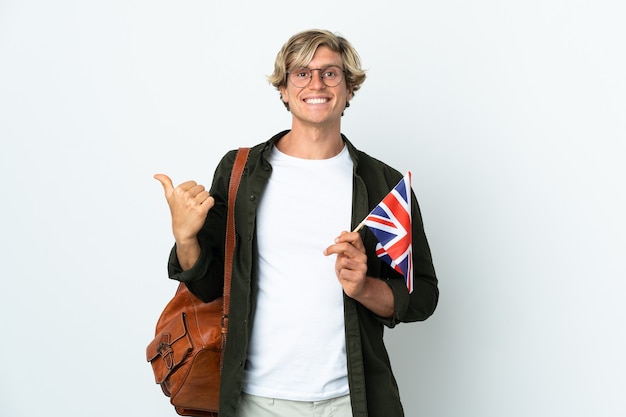 Jeune femme anglaise tenant un drapeau du Royaume-Uni pointant sur le côté pour présenter un produit