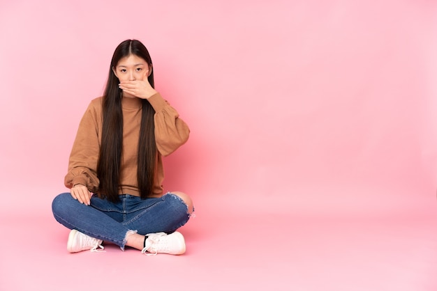 Jeune femme asiatique assise sur le sol