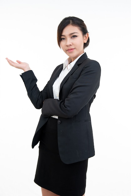 Jeune femme asiatique en costume noir ouvre sa paume avec le sourire