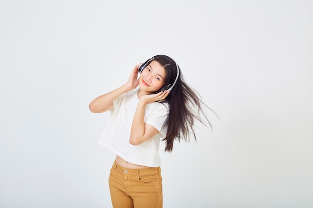 Jeune femme asiatique avec des écouteurs dansant