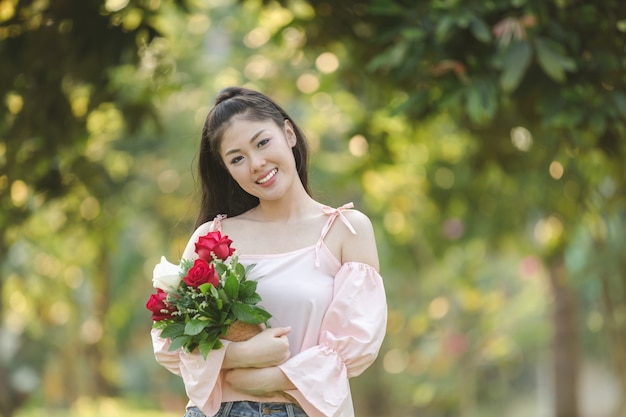 jeune femme asiatique fille avec des roses rouge souriant hoppy en Saint Valentin