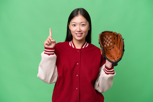 Jeune femme asiatique avec un gant de baseball sur fond isolé montrant et levant un doigt en signe du meilleur