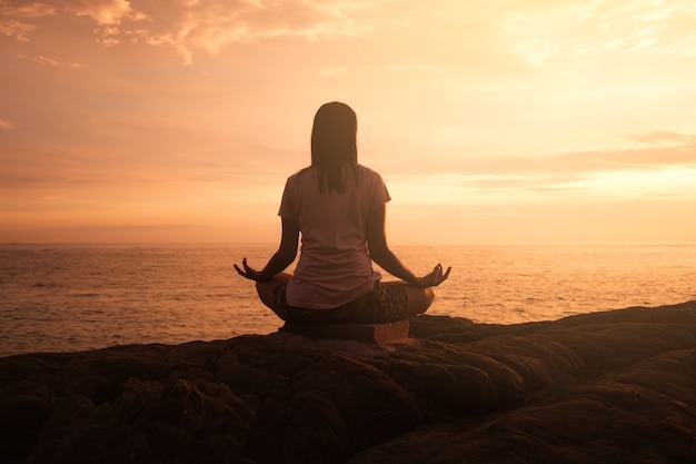 Jeune femme asiatique silhouette, pratiquer l&#39;yoga pose à la plage, concept pour Yoga Sport et mode de vie sain