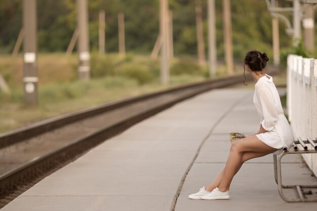 Jeune femme attendant quelqu'un à la gare