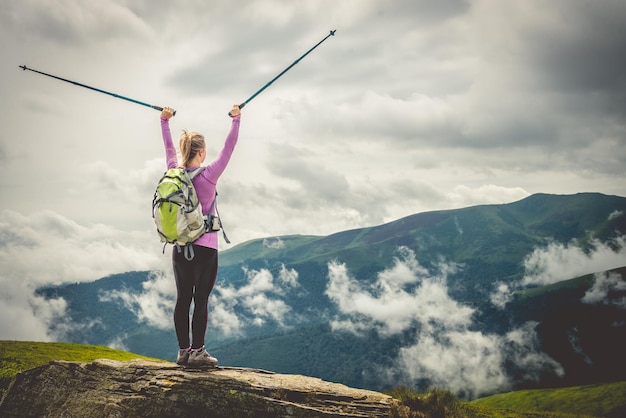 Jeune femme au sommet des montagnes