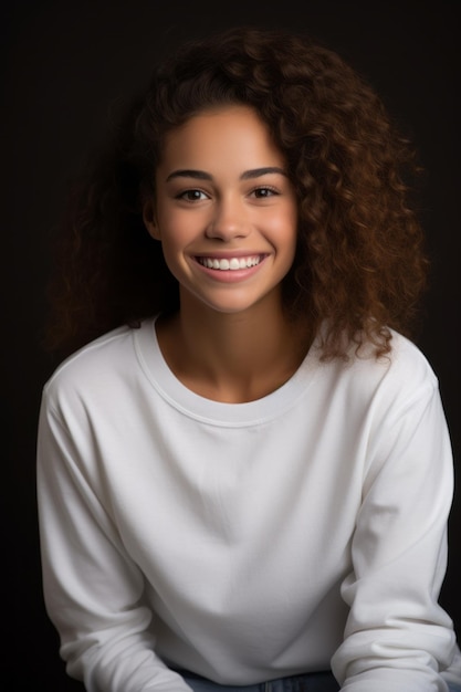 une jeune femme aux cheveux bouclés souriant à la caméra