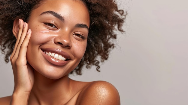 Une jeune femme aux taches de rousseur s'applique une crème blanche sur le visage sur un fond neutre